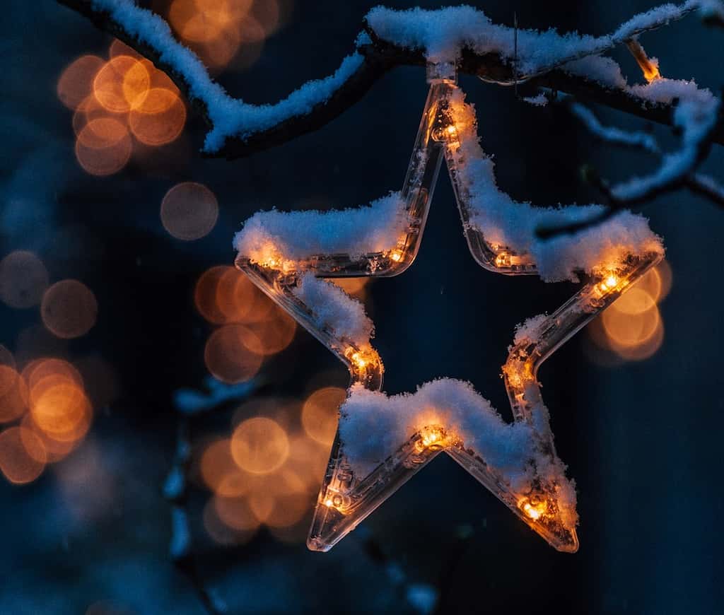 Christmas star decoration with festive lights for holiday season opening hours announcement.